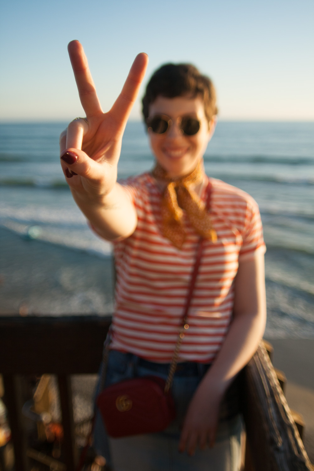 Peace sign on the beach at sunset